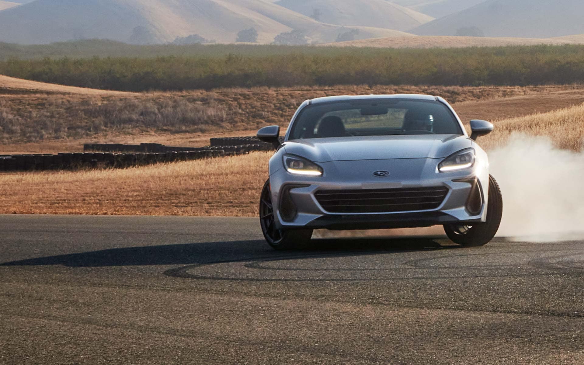 2022 Subaru BRZ Limited shown in Ice Silver Metallic rounding a curve on a highway.